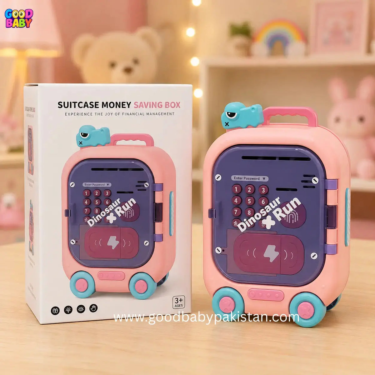 Pink suitcase-shaped money saving box with dinosaur design next to its packaging on a wooden surface.