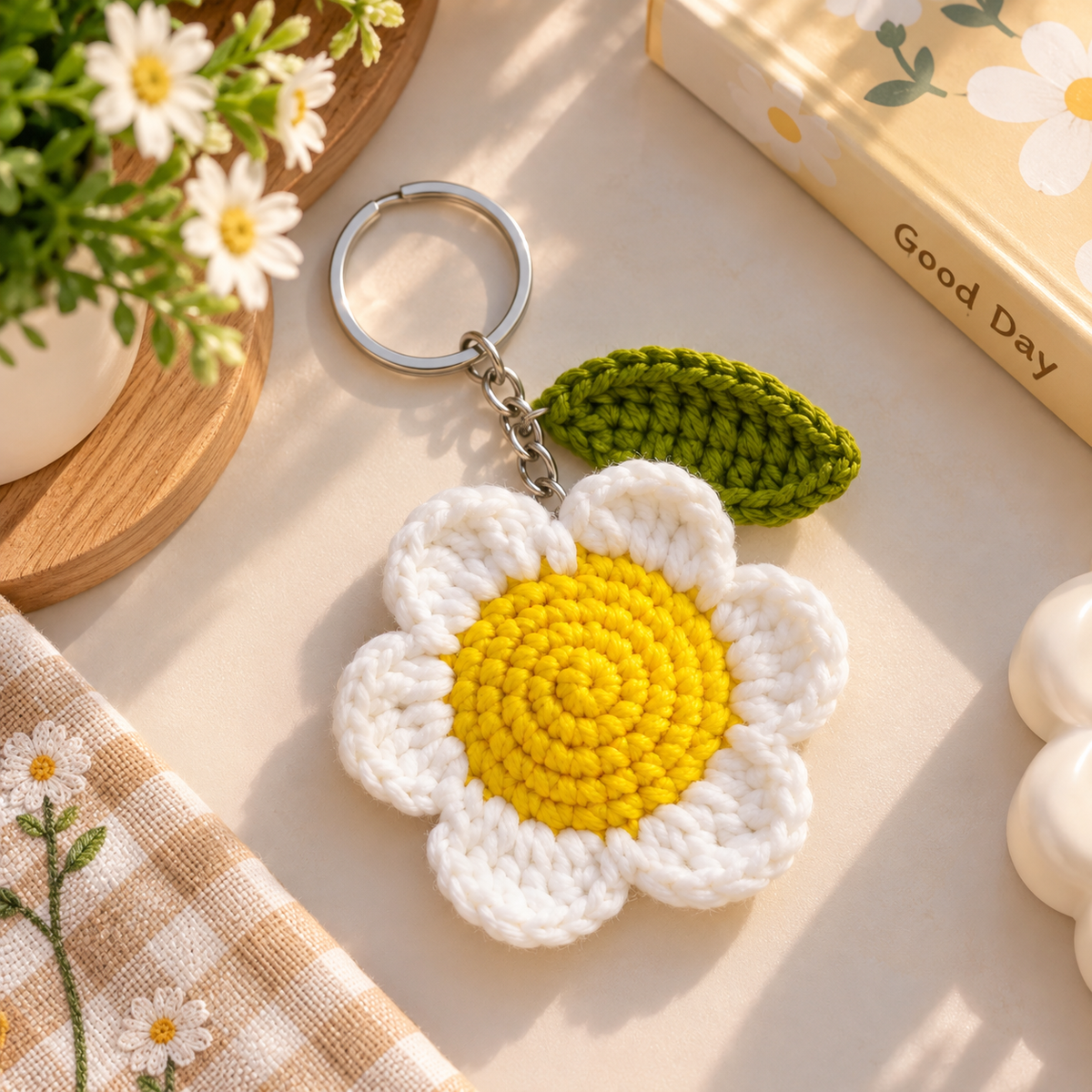 Handmade crochet daisy keychain with leaf charm