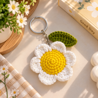 Handmade crochet daisy keychain with leaf charm