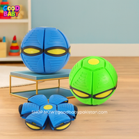 Two transforming toy balls, one blue and one green, on a wooden floor with a colorful background.