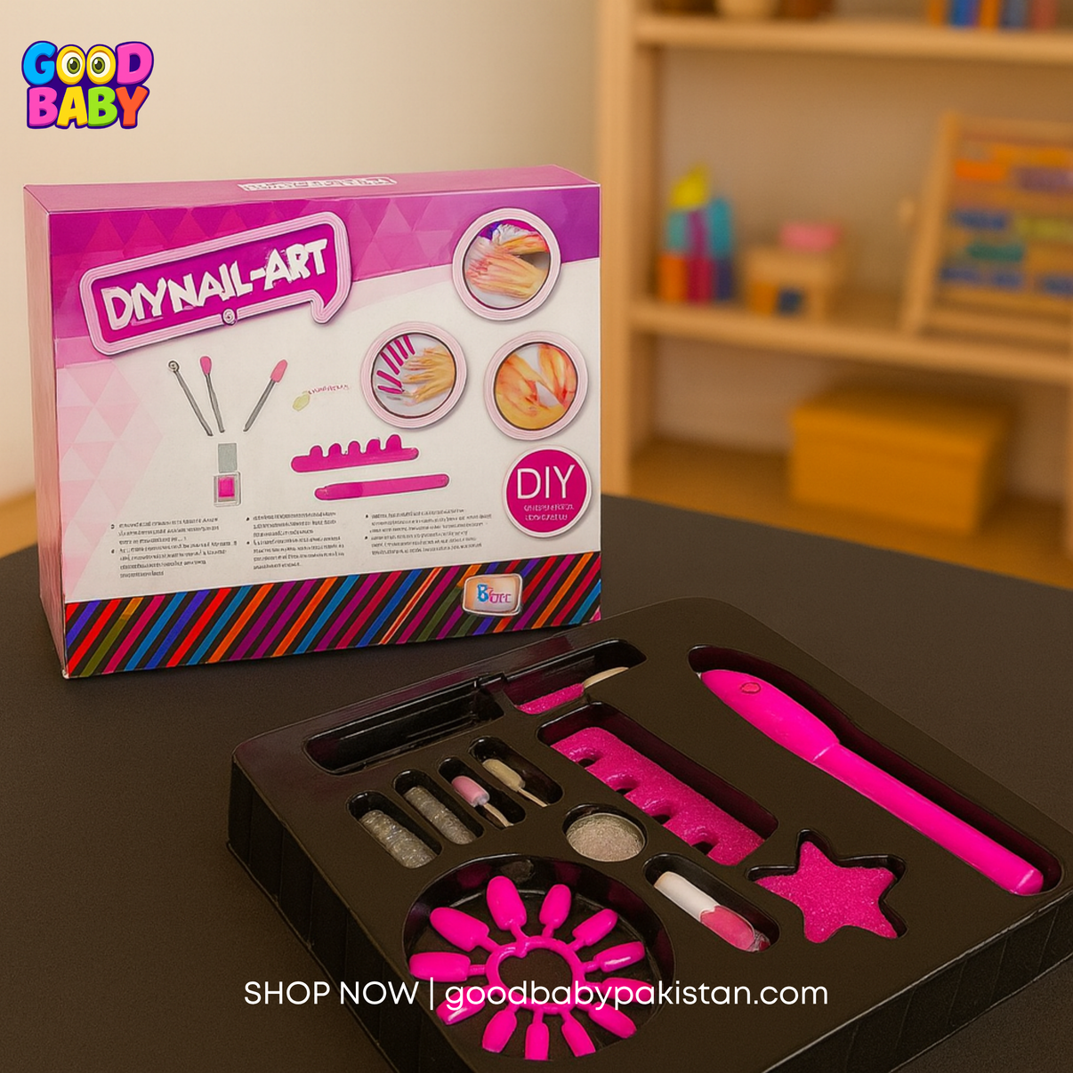 Good Baby DIY nail art kit with tools and colors on a table, branded packaging in the background.