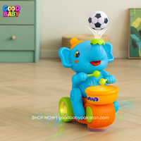 Toy elephant with soccer ball on a wooden floor, brand 'Good Baby' visible