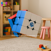 Colorful Rubik's cube toy with a brand logo on a carpeted floor in a room with children's toys.